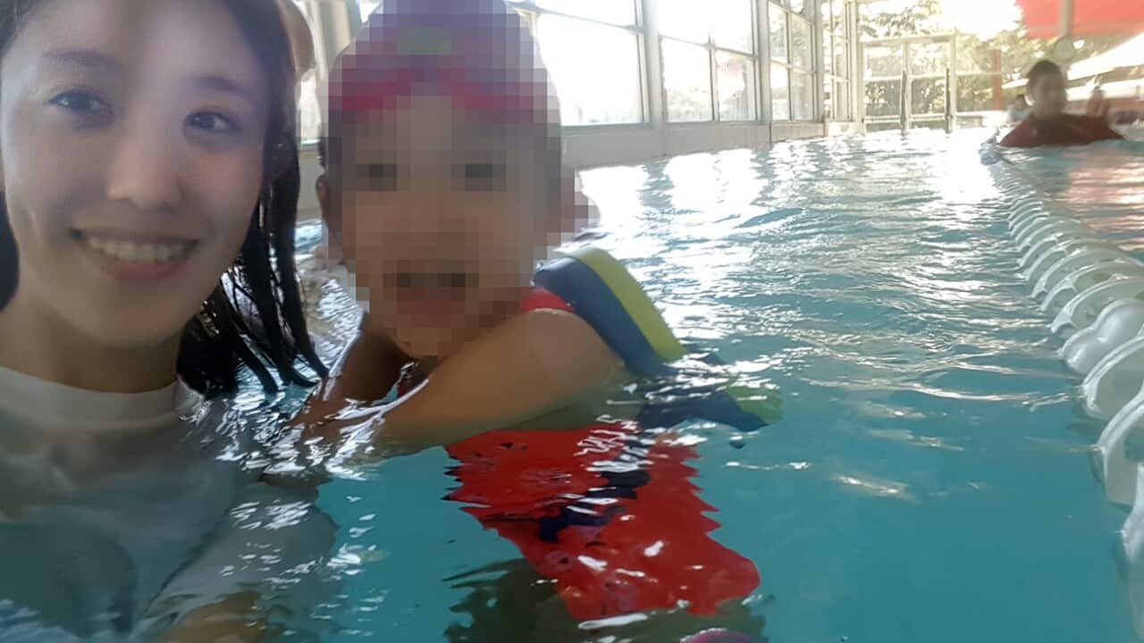 Miss Sun Hyung Lee giving a swimming lesson to children in Sydney