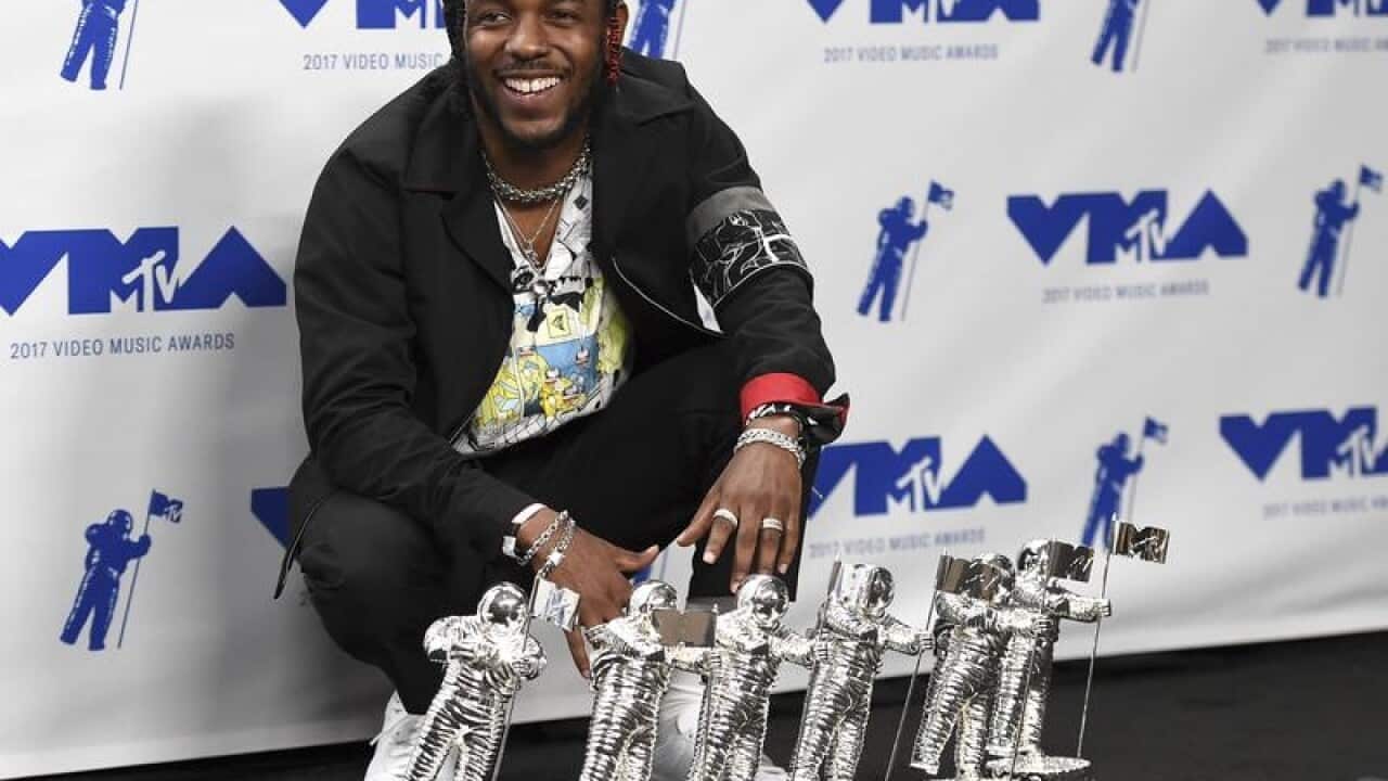 Kendrick Lamar poses with his six MTV VMA awards