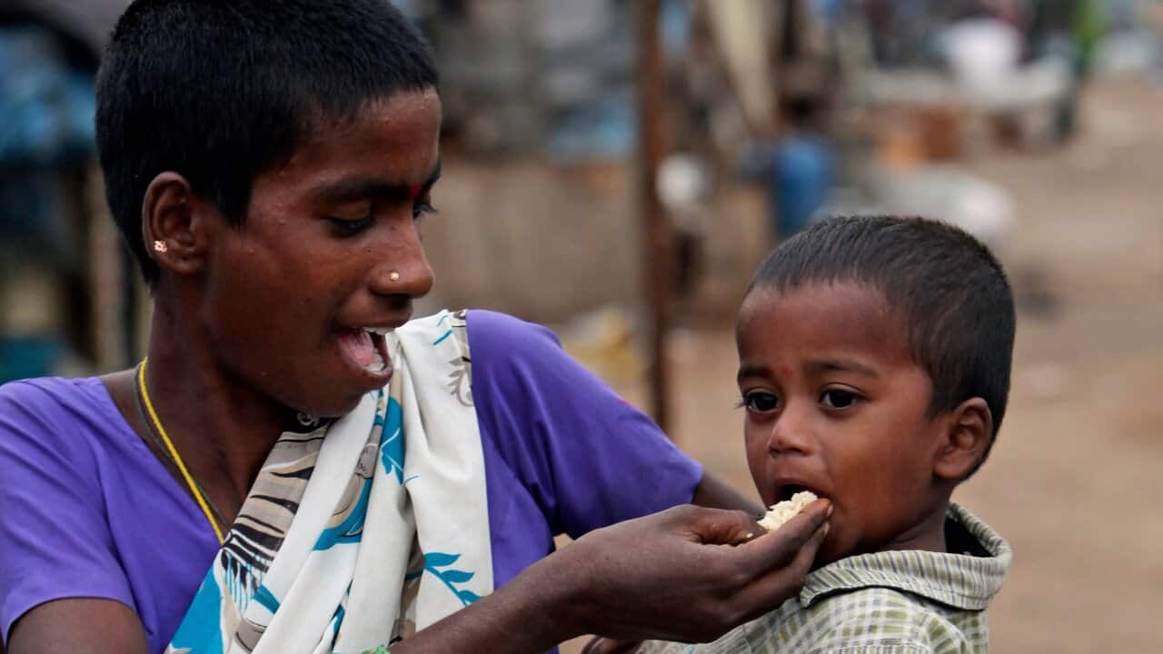 An Indian woman feeds her child at a shanty area in Hyderabad, India, Tuesday, Jan. 10, 2012.