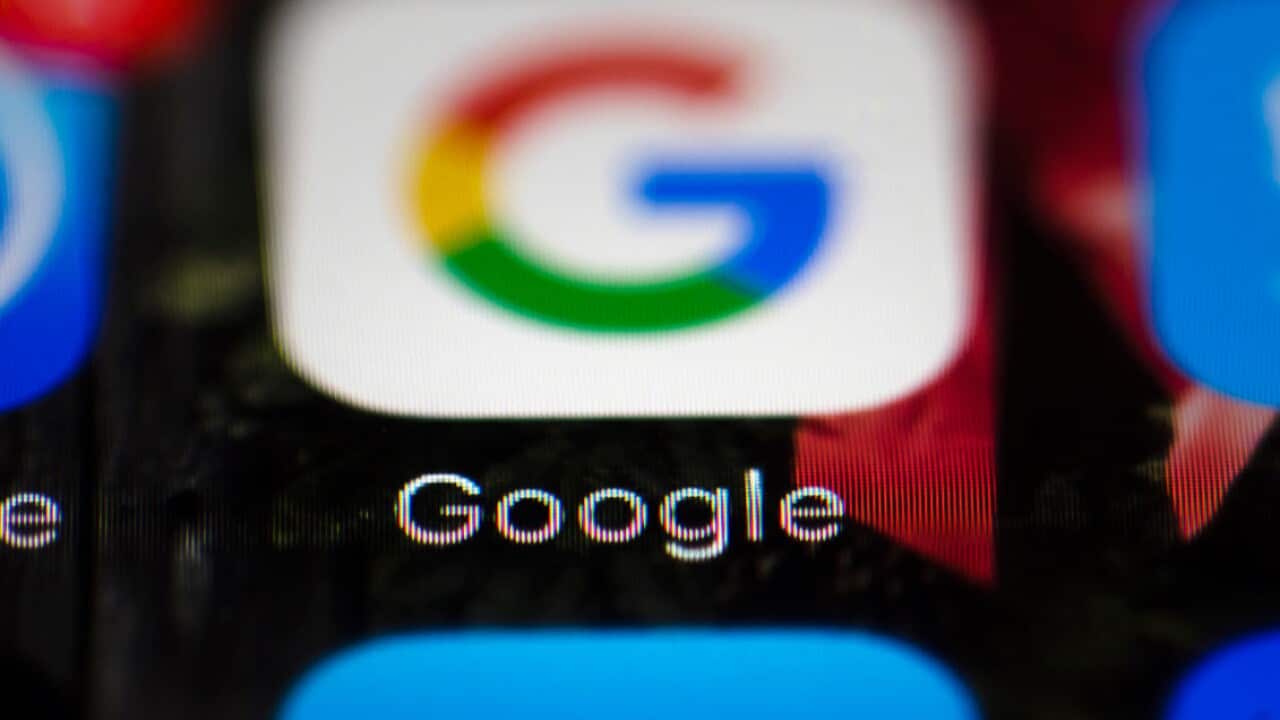 A file photo shows a Google icon on a mobile phone. 