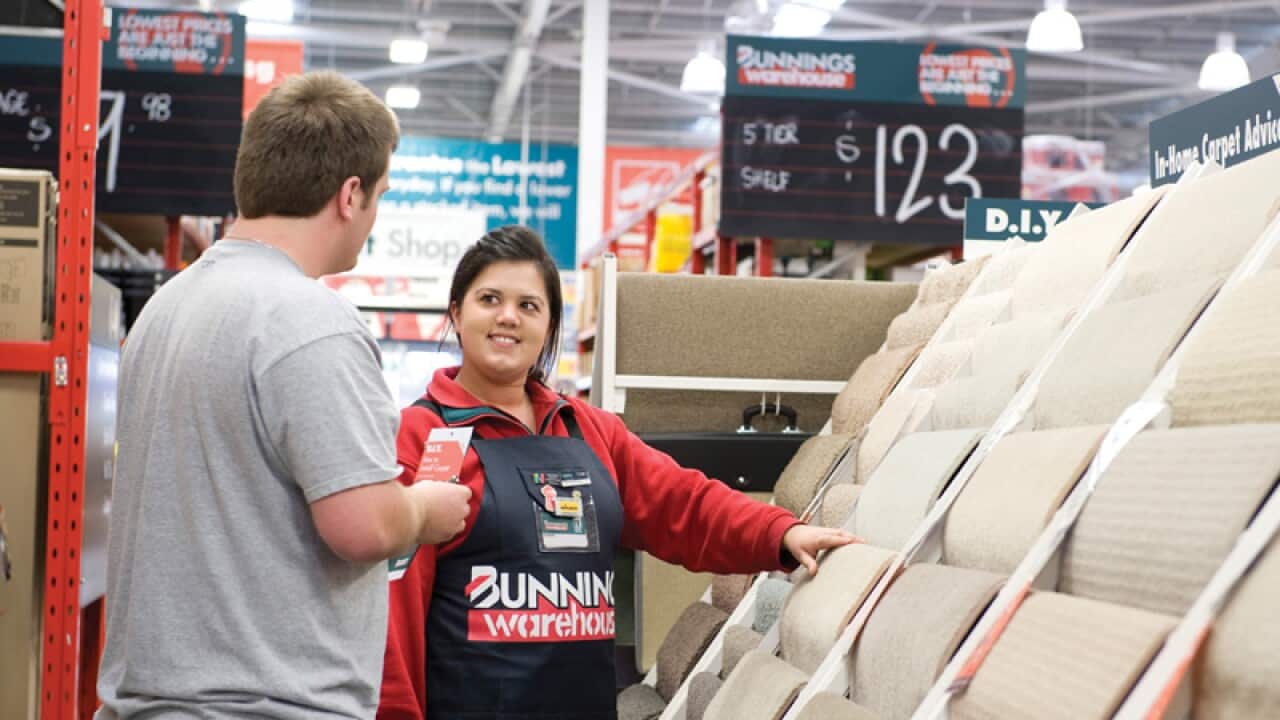 A Bunnings employee assisting a customer