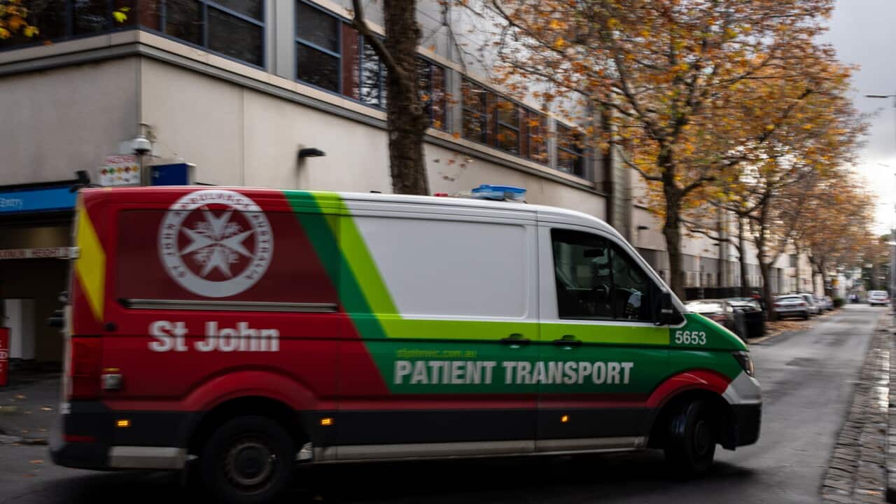 A vehicle for transporting patients drives onto a Melbourne street