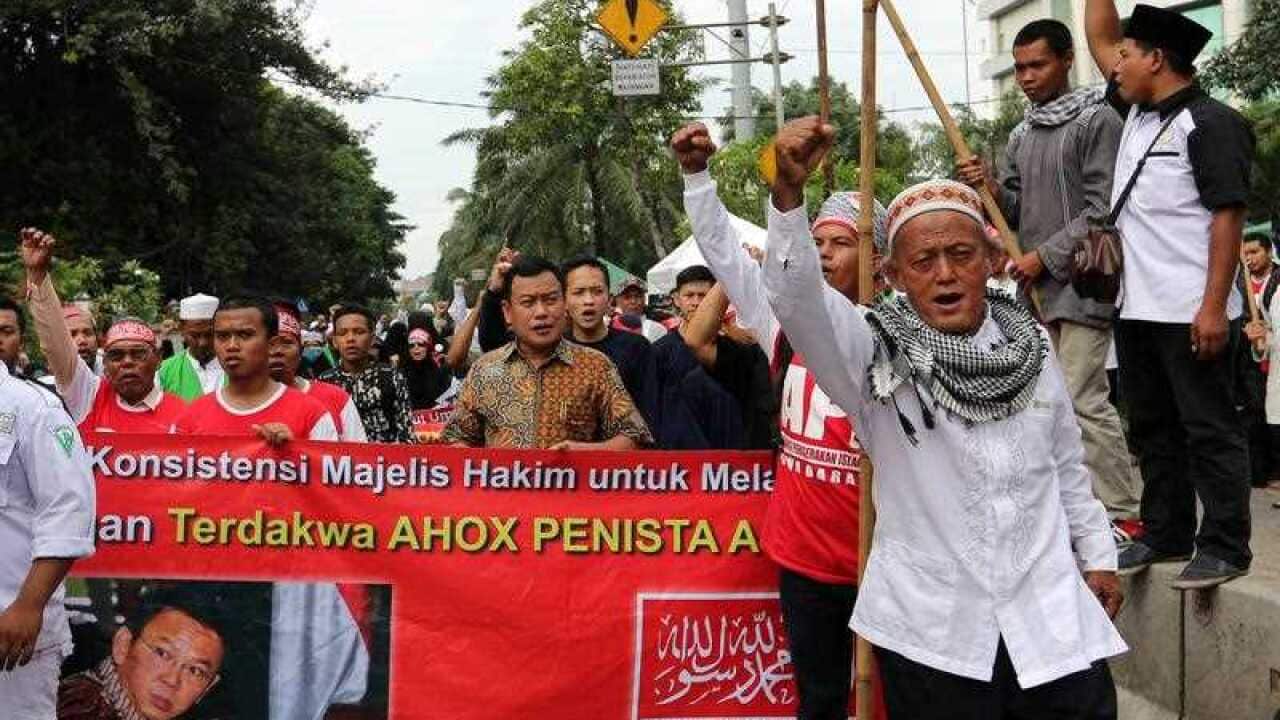 Muslim protesters hold a banner during a protest against Jakarta's governor in Jakarta, Indonesia, 11 April 2017. 