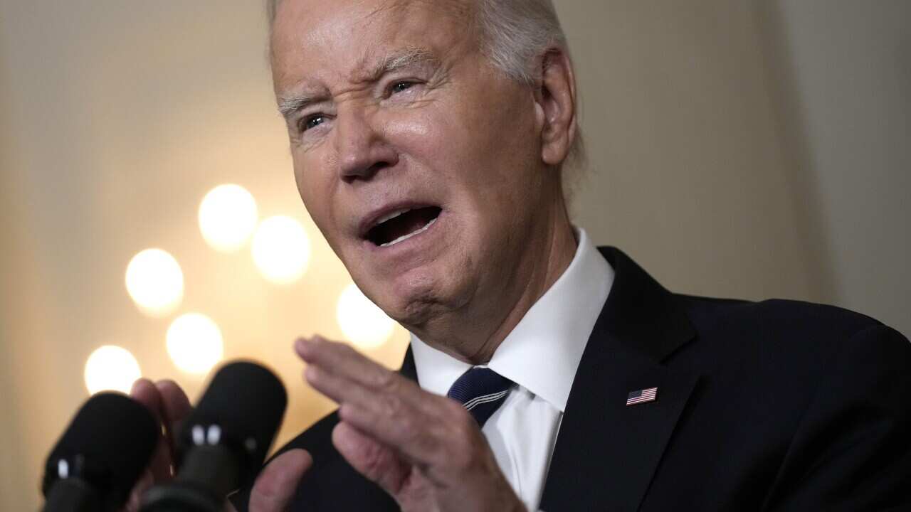 Close up of man delivering speech while gesticulating with hands at a podium.