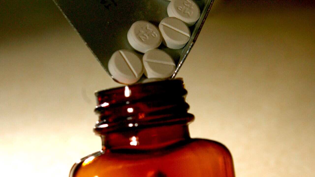 Tablets are measured out in a high street pharmacy.