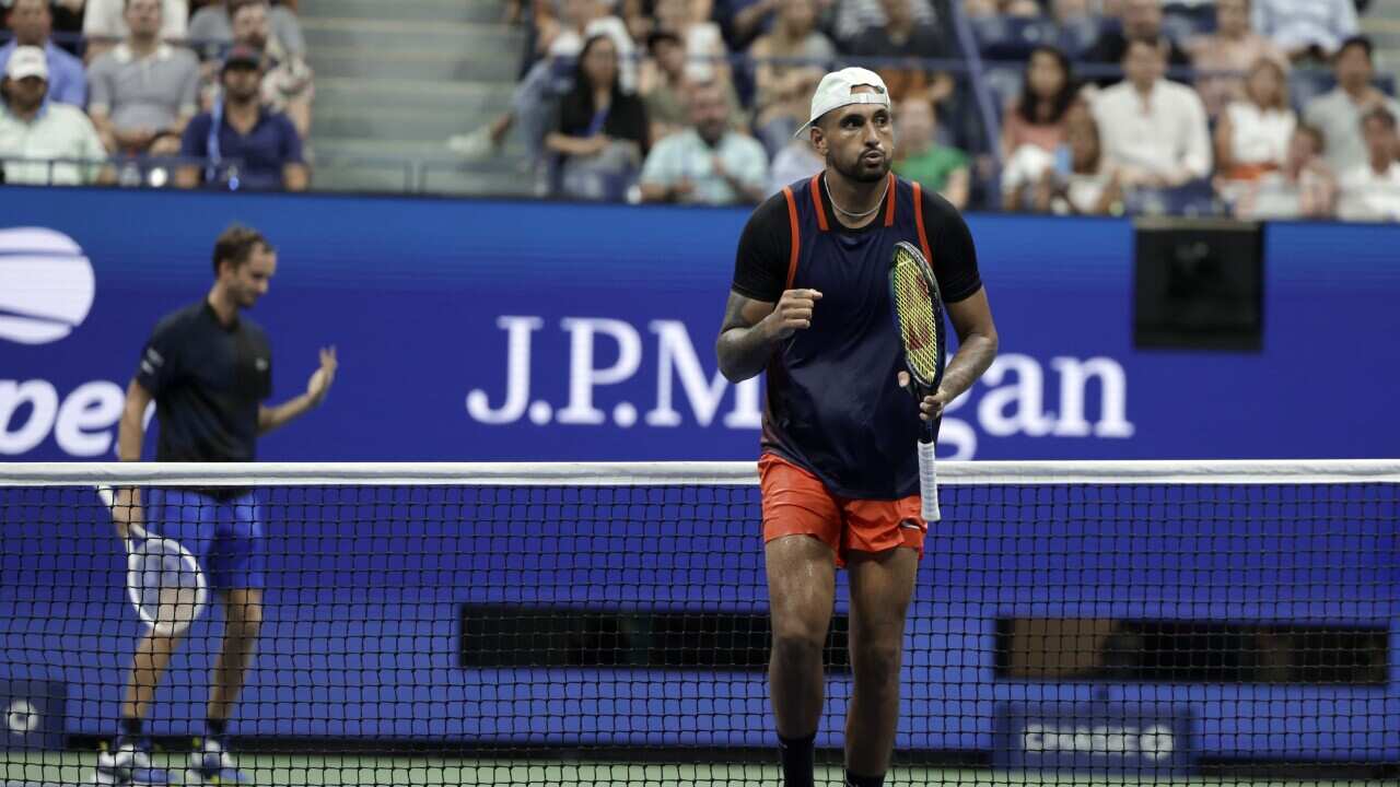 Nick Kyrgios, of Australia, celebrates winning a point against Daniil Medvedev, rear, of Russia, during the fourth round of the U.S. Open tennis championships