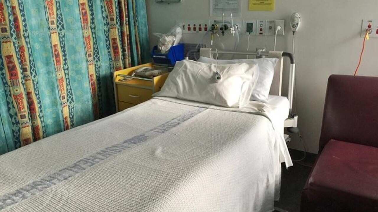 An empty bed in a recovery room