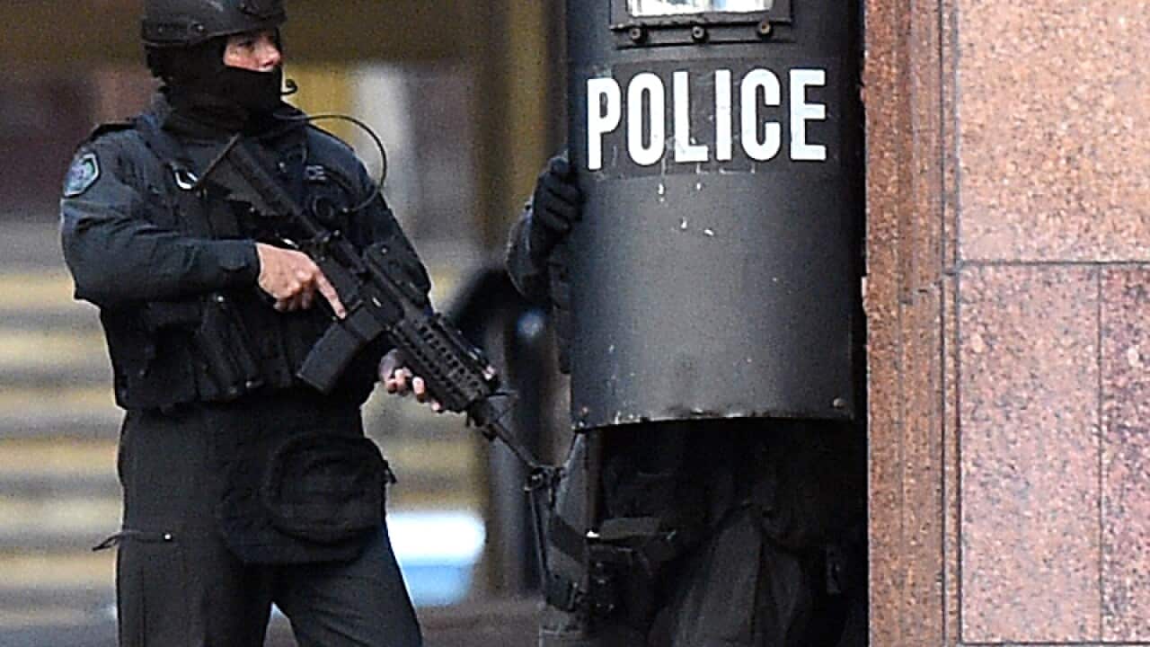 NSW Tactical Police are seen on Phillip Street in the central business district of Sydney, Monday, Dec. 15, 2014. (AAP Image/Dan Himbrechts) 