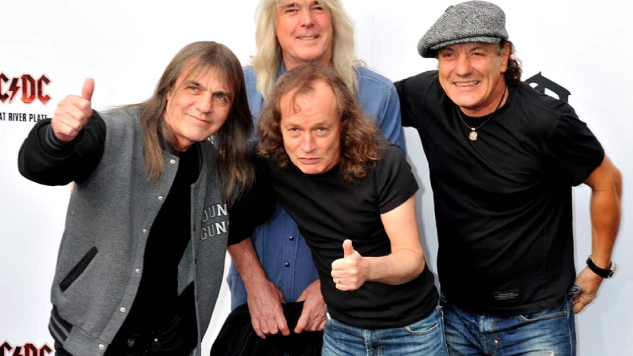 AC/DC guitarist Malcolm Young (L)