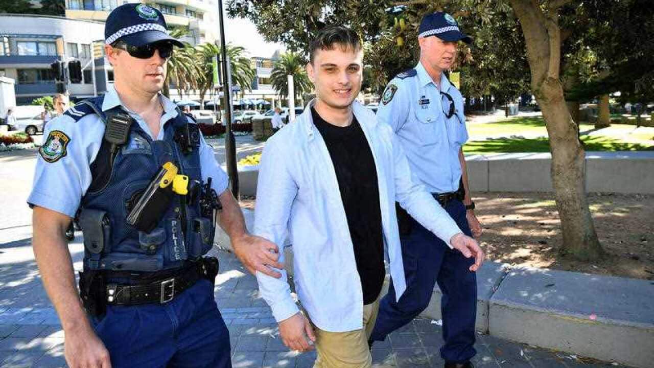 NSW Police detain a man after a confrontation with a photographer following a press conference with Senator Fraser Anning