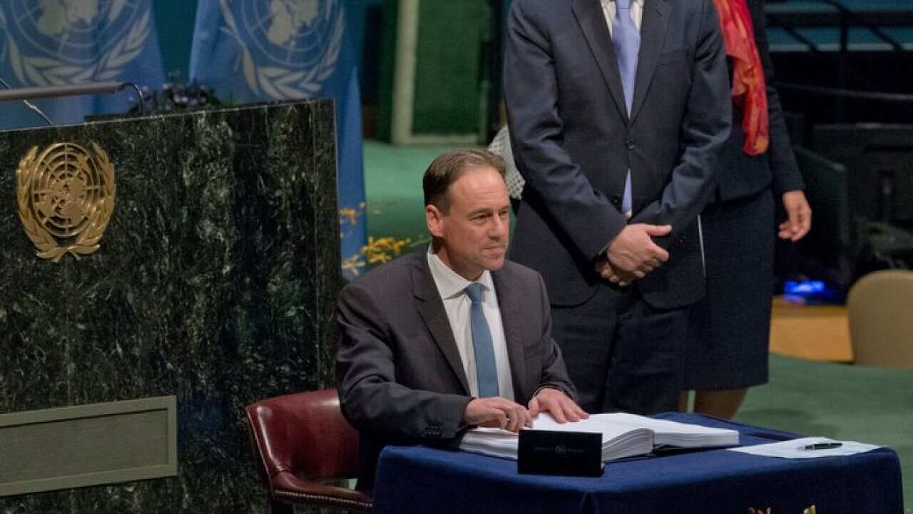 Australian Minister for the Environment Greg Hunt signs the Paris Agreement on climate change