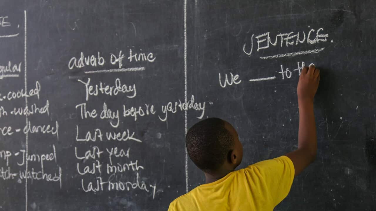 A primary student writing on the black board during an English language class in Tanzania, Dar Es salaam.