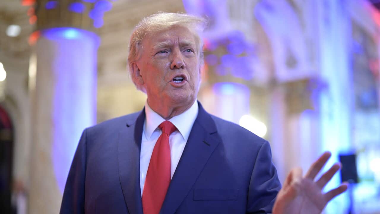 A mean wearing a suit and tie who is speaking.