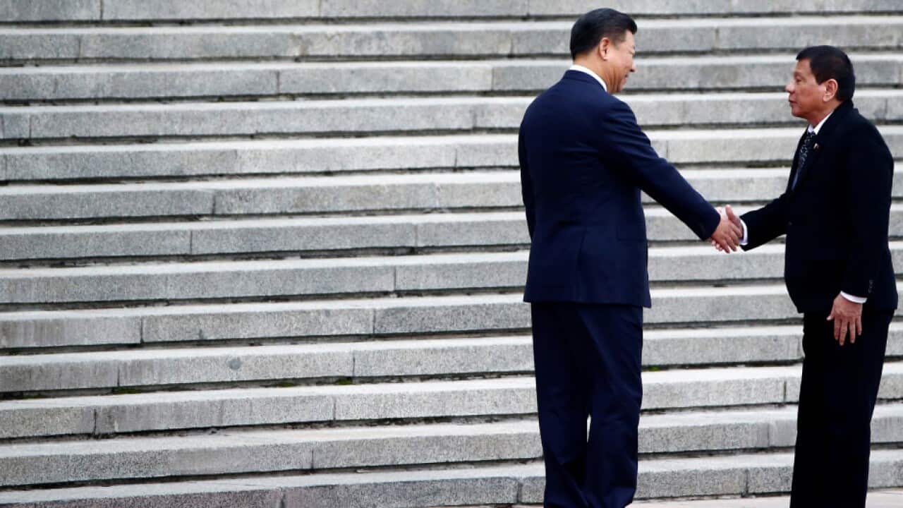 Philippines President Duterte and Chinese President Xi shake hands as they attend a welcoming ceremony at the Great Hall of the People in Beijing,