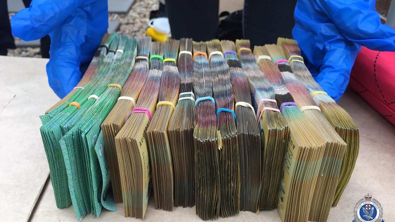 Bundles of cash seized by police after a drug raid in 2020