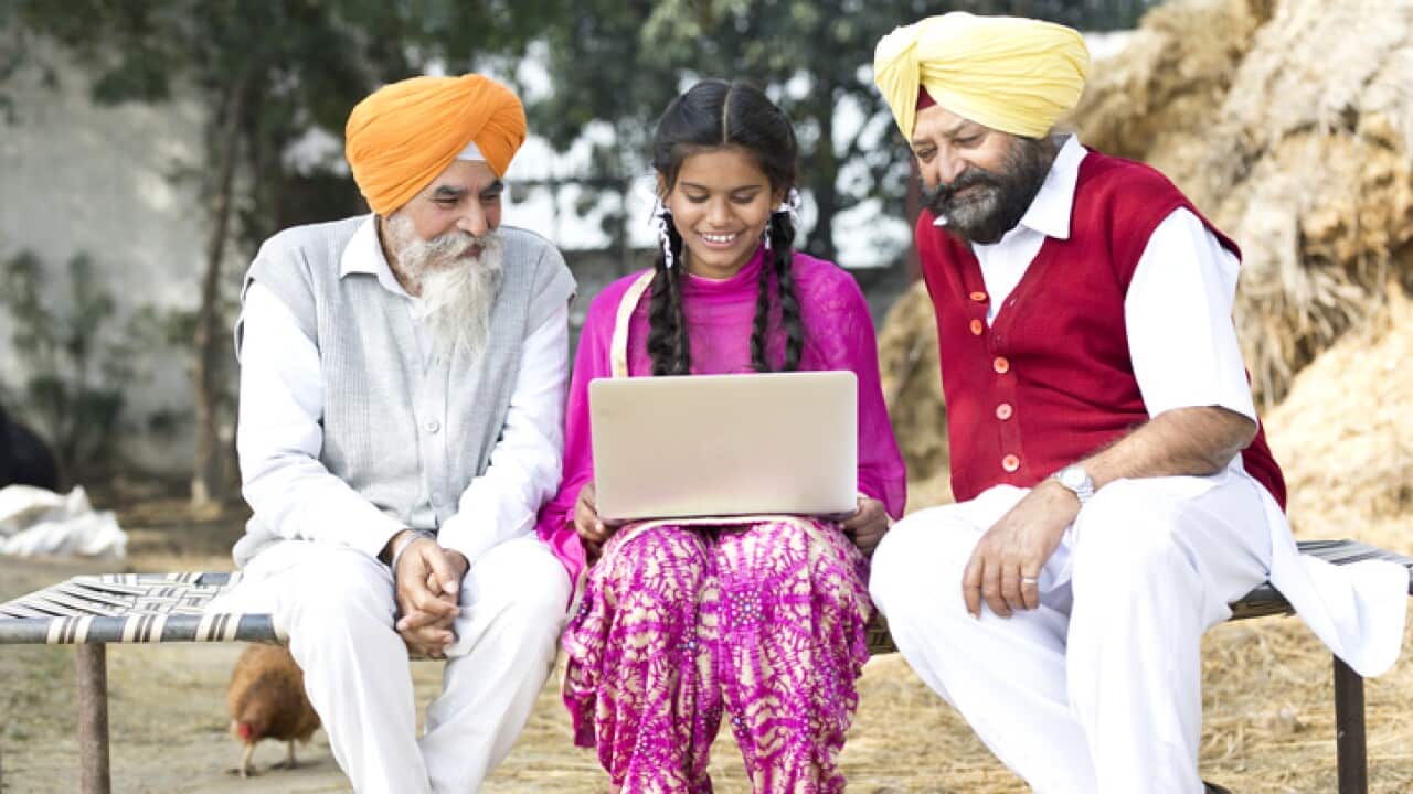 Indian men with girl using laptop