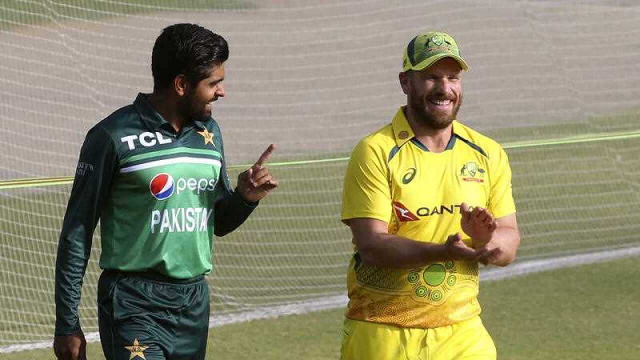 Pakistan's skipper Babar Azam, left, chats with his Australian counterpart Aaron Finch as they arrive to unveil the ODI series trophy at the Gaddafi Stadium in Lahore, Pakistan, Monday, March 28, 2022.