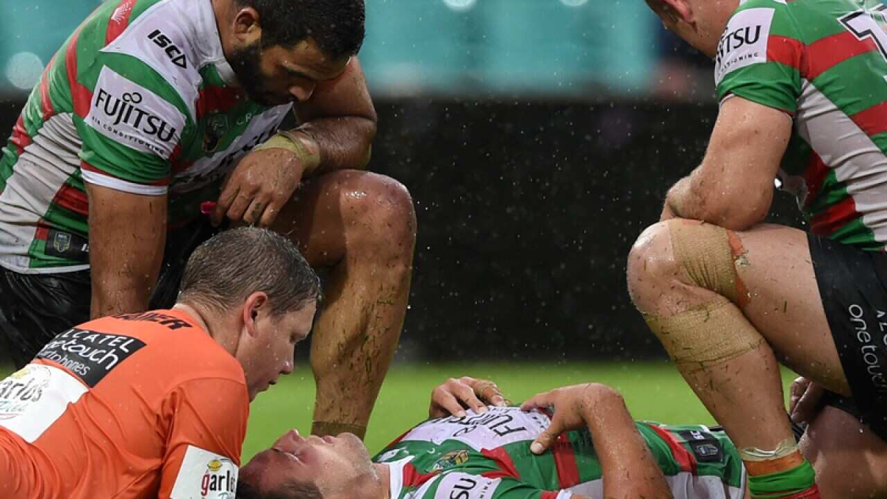 Sam Burgess (centre) received medical attention.