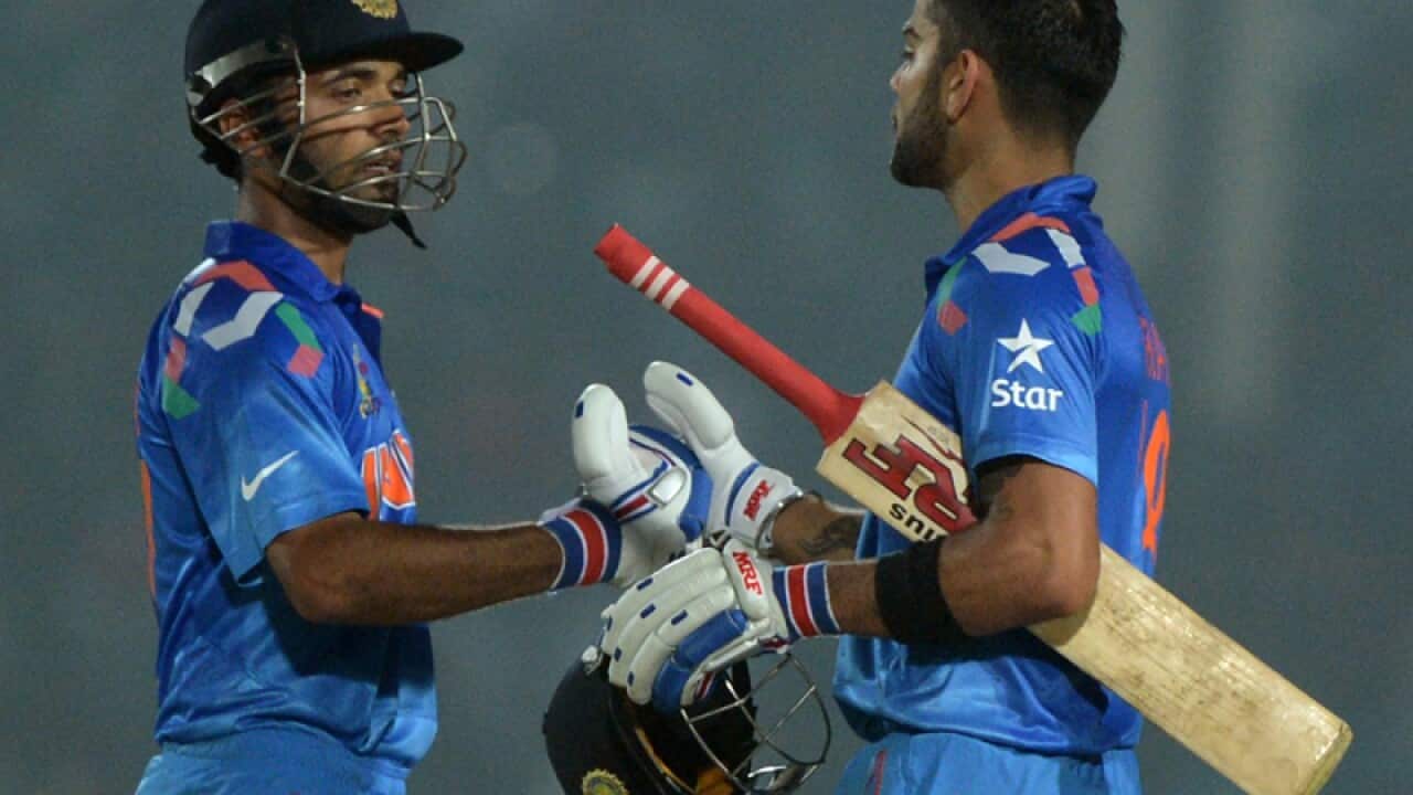 Indian captain Virat Kohli (R) celebrates scoring a century