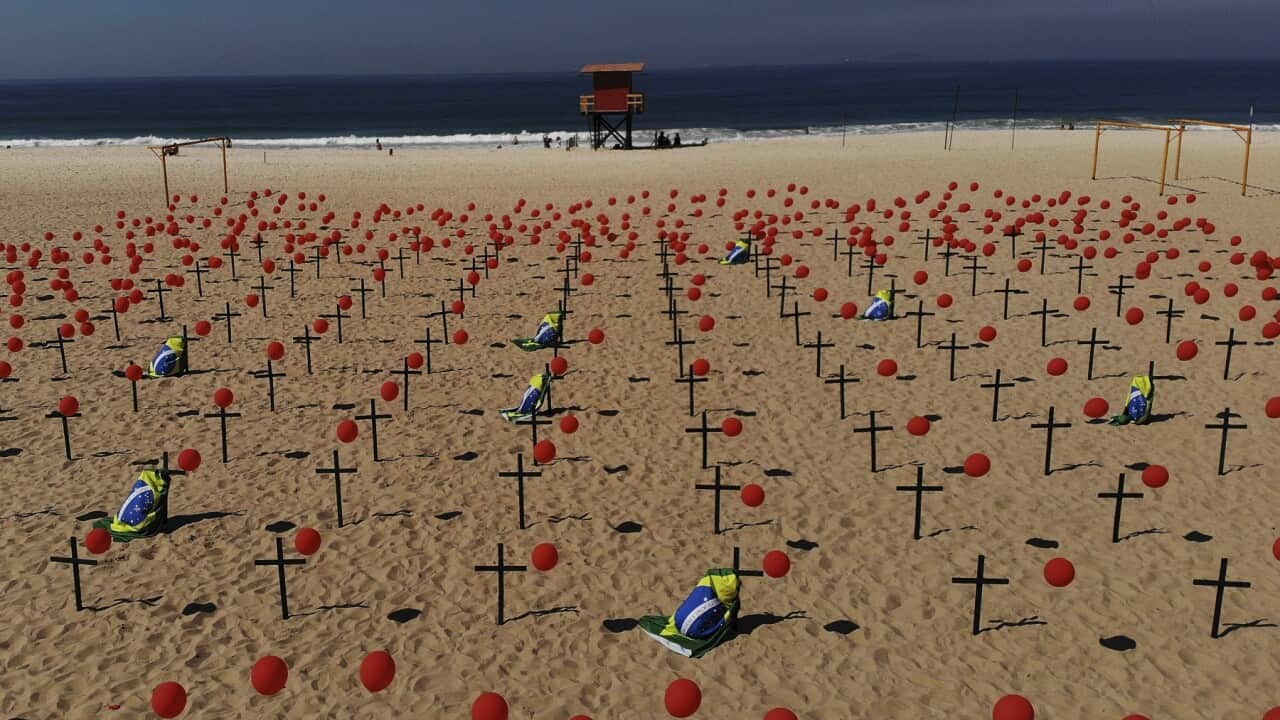Crosses, red balloons and Brazilian nation flags on Copacabana beach to honour COVID-19 victims