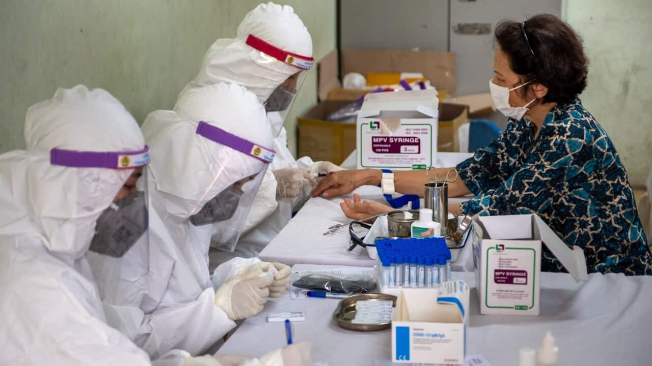 Vietnamese medical specialists collect blood samples for a coronavirus (COVID-19) rapid test (Linh Pham - Getty)
