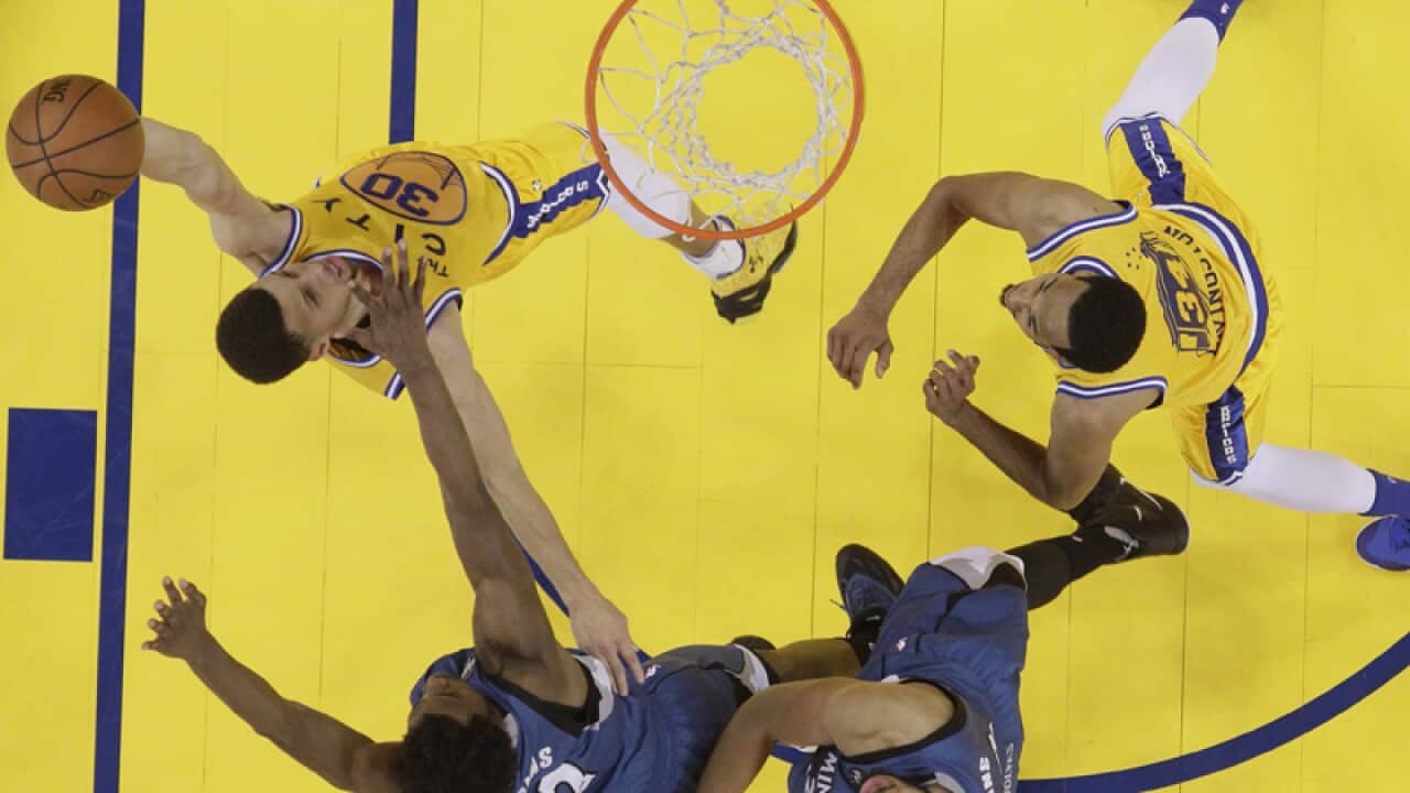 olden State Warriors' Stephen Curry (L) goes for a shot
