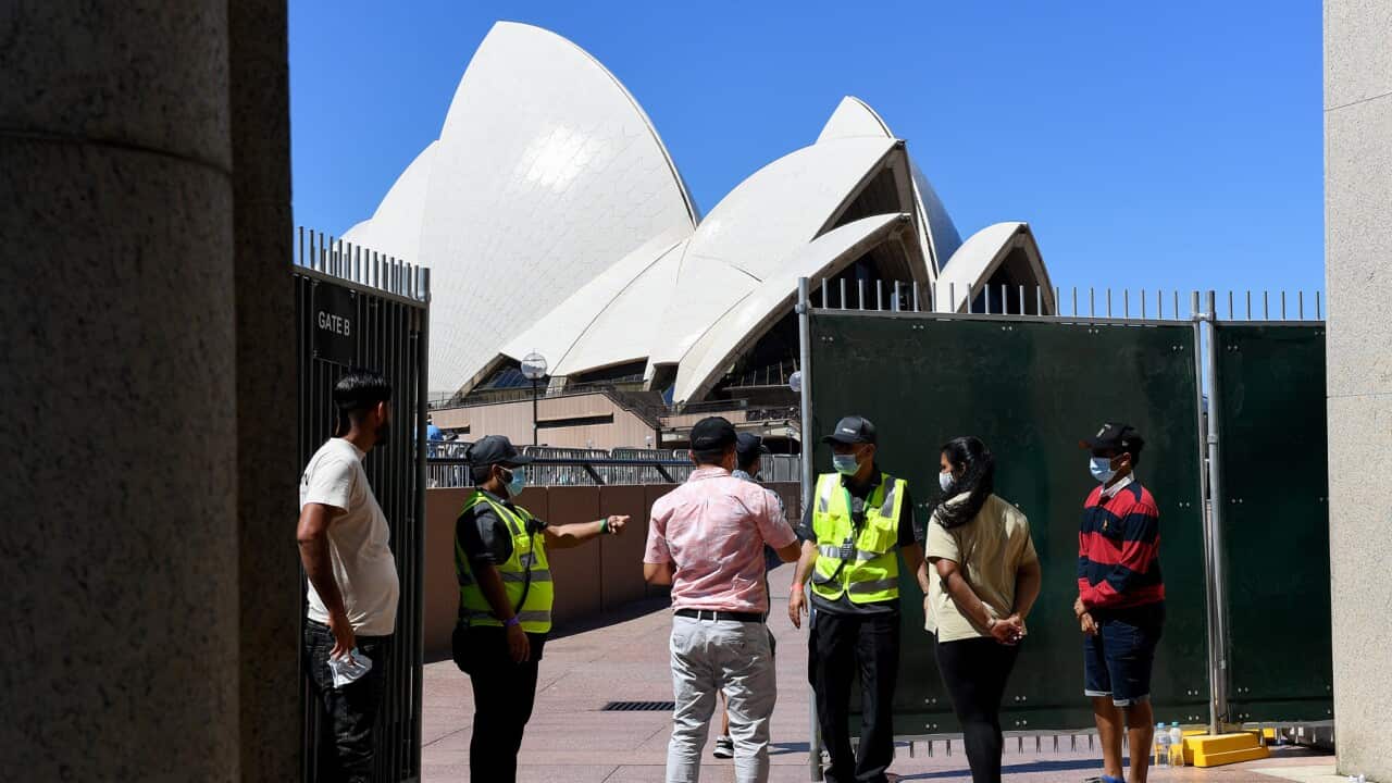 Security guards check entry tickets at the Sydney Opera House