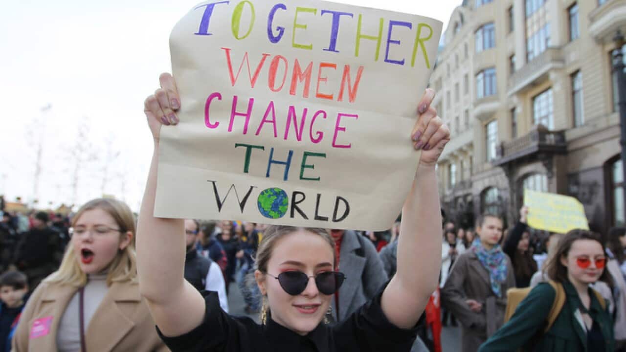 An activist at a Ukrainian protest march takes a stand against violence