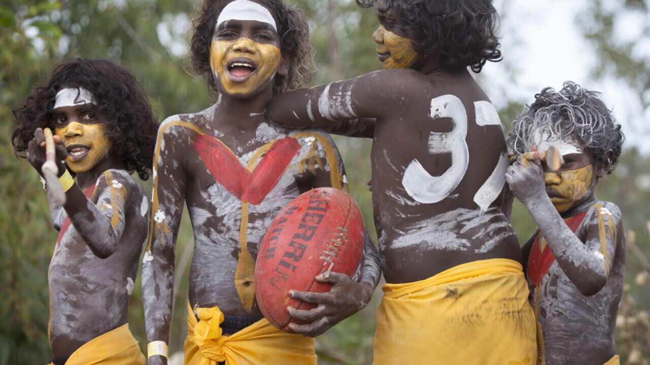 Aboriginal dancers with red and white paint to support Adam Goodes
