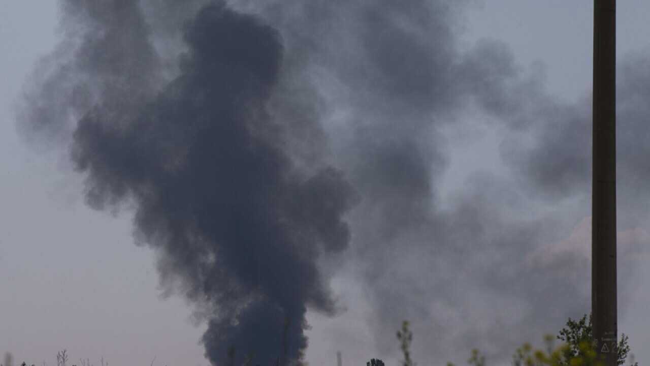 Black smoke rises from a shot down Ukrainian Army helicopter