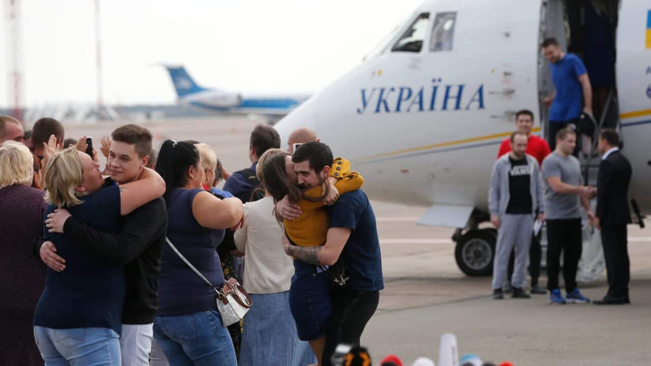 Planes carrying prisoners freed by Russia and Ukraine land in the countries' capitals.