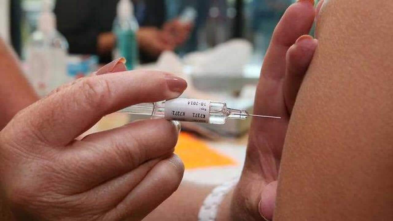 Healthcare workers receive the flu vaccination injection.