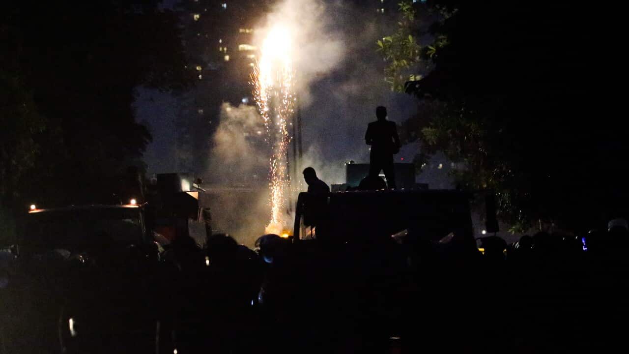 Sparks amid a crowd of protesters.