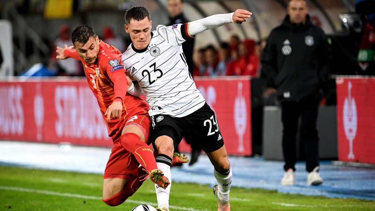 Germany's Florian Wirtz in action against North Macedonia's Stefan Askovski during the FIFA World Cup Qatar 2022 qualifying soccer match. EPA/GEORGI LICOVSKI