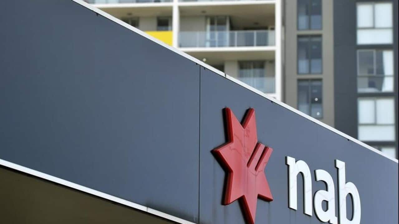 Residential apartment housing seen behind NAB bank signage