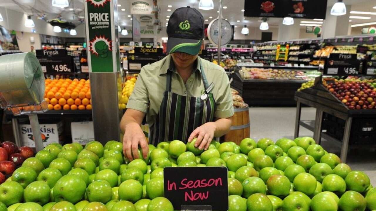 An employee inside a Woolworths grocery store in Brisbane