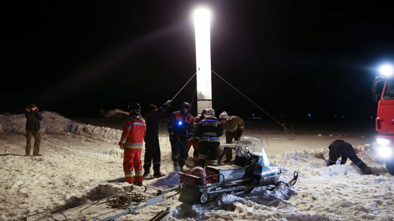 In this photo provided by the Russian Emergency Situations Ministry, RMES employees work at the scene of a AN-148 plane crash