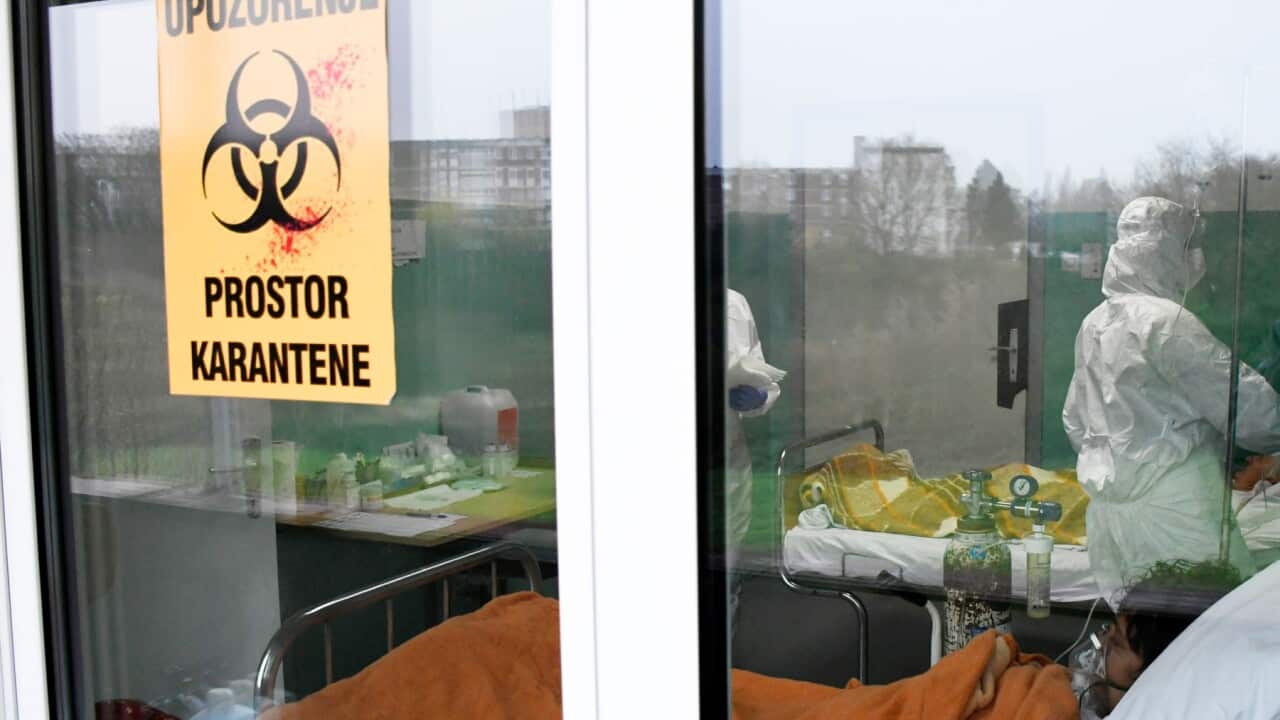 A doctor checks a COVID-19 patient in the Intensive Care Unit of the General Hospital in Sisak, Croatia