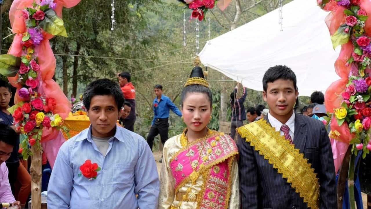 An Akha couple dressed in Lao style clothing at their wedding in Luang Namtha province, Lao PDR (Tessa Bunney - In Pictures via Getty Images)