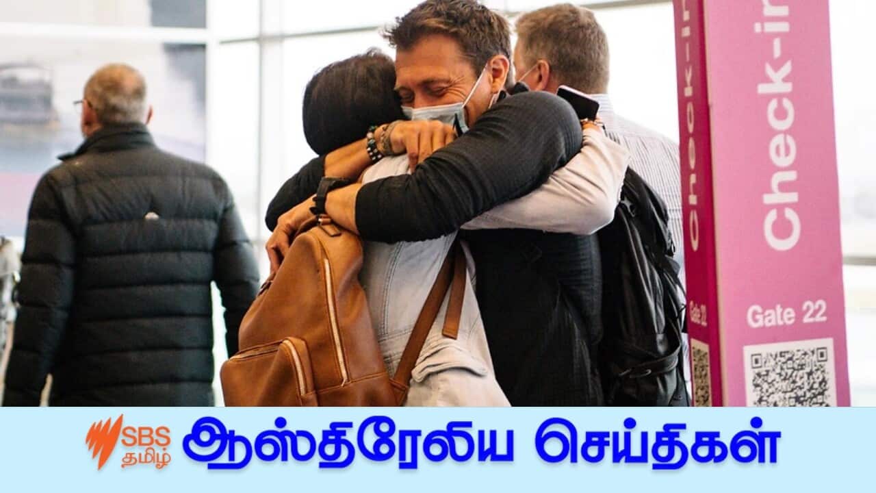 Two people are seen hugging each other after one arrives from a Melbourne flight this morning in Adelaide.