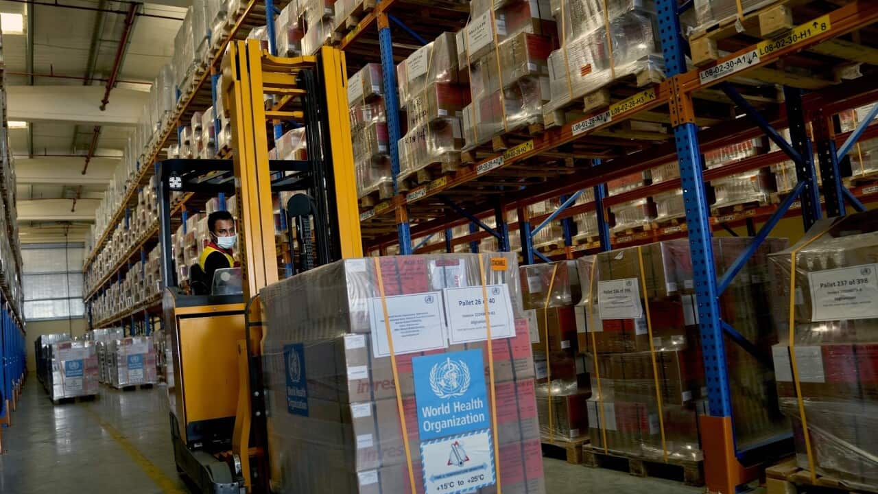A forklift driver loads healthcare materials to be sent to Afghanistan at a UNHCR warehouse