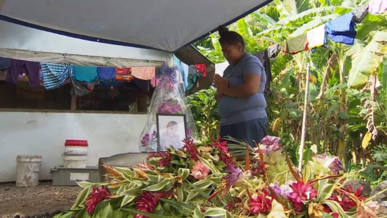 A mother grieves for her child who died of suspected measles.
