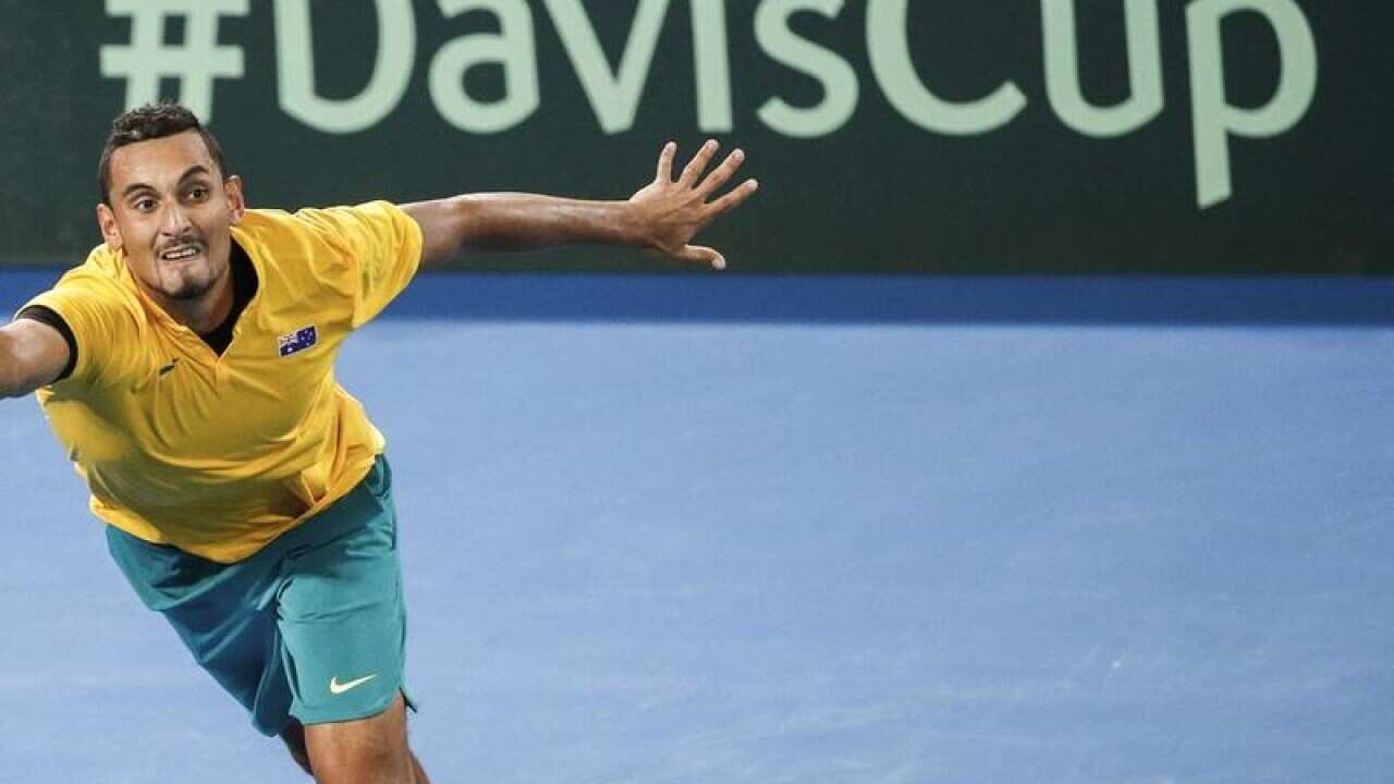 Nick Kyrgios in front of a Davis Cup sign