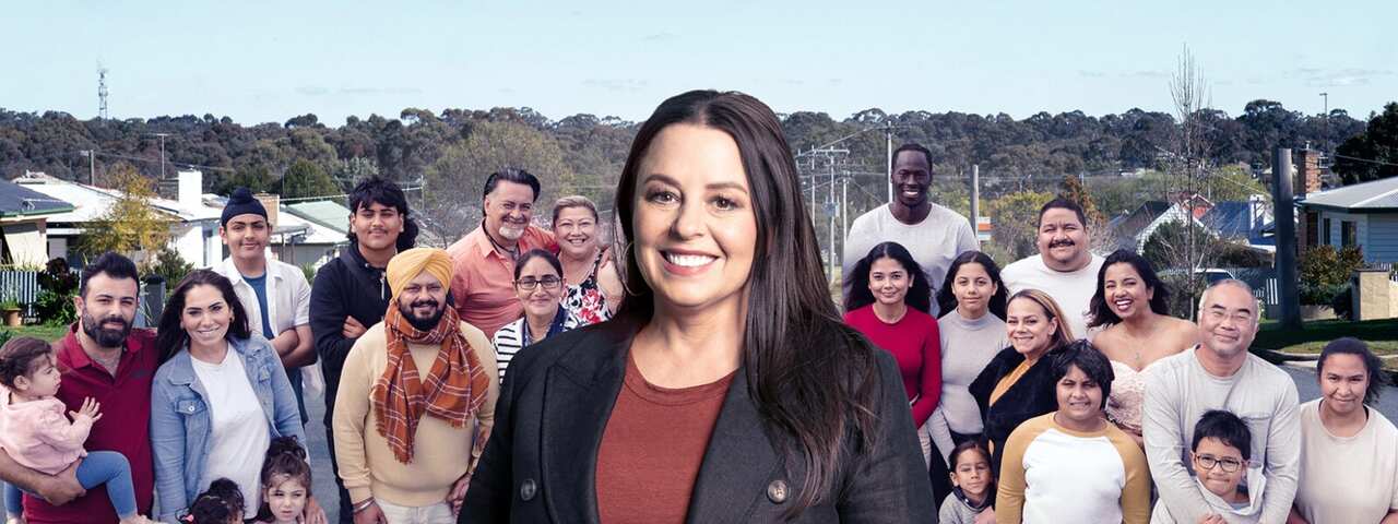 A composite image shows a woman in a dark jacket, standing in front of a group of people. They appear to be of various ages and cultural backgrounds.