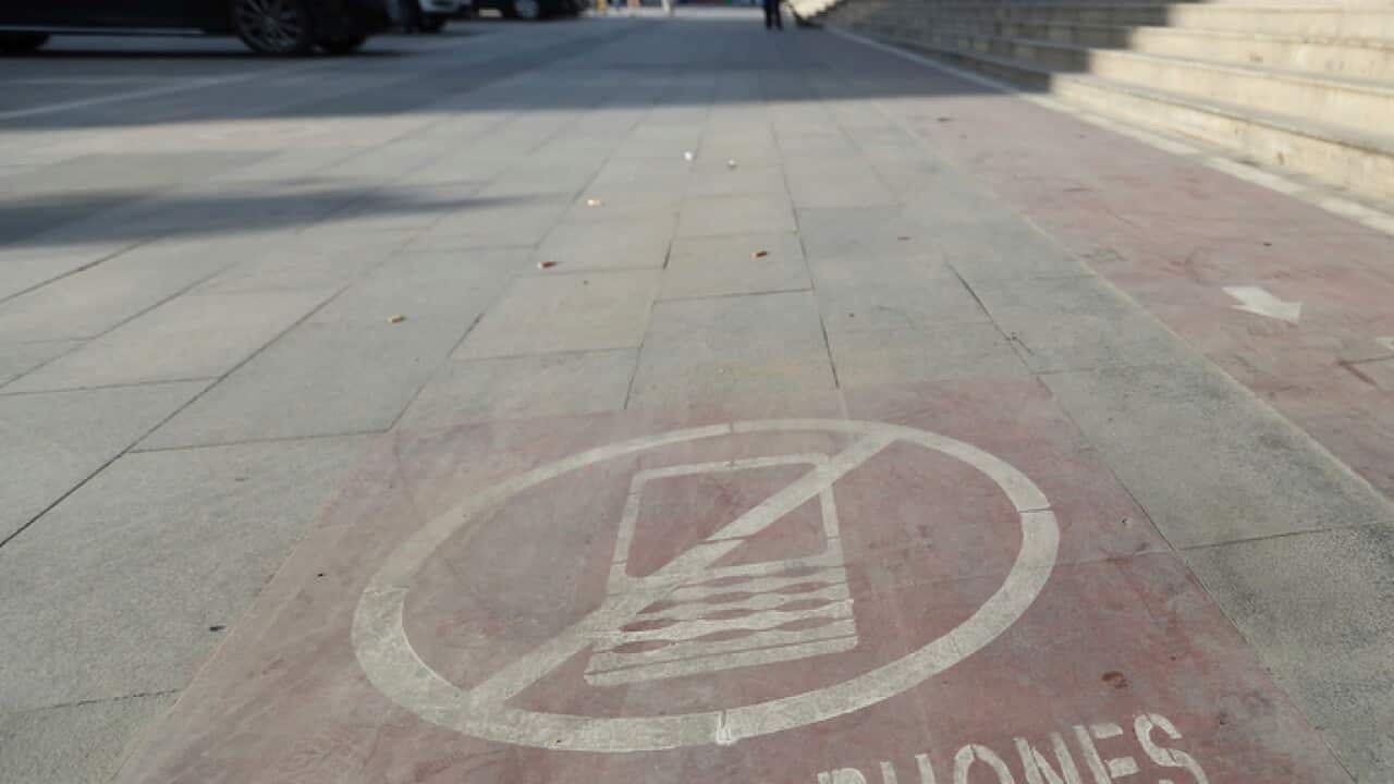 A signage of cellphone is pictured on the mobile phone sidewalk lane for phubbers