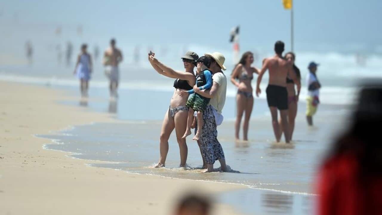 Beachgoers cool down at Surfers Paradise