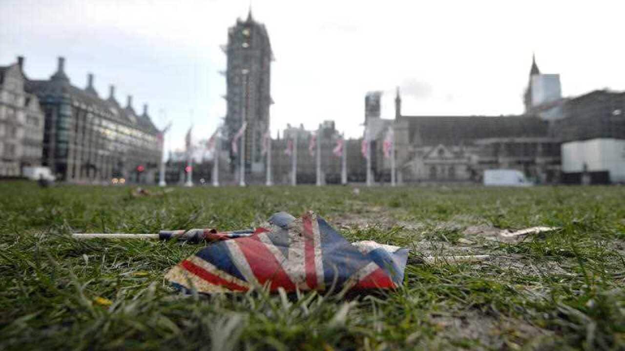 Union flags left discarded on the mud and grass at Parliament Square in London, following Brexit celebrations.