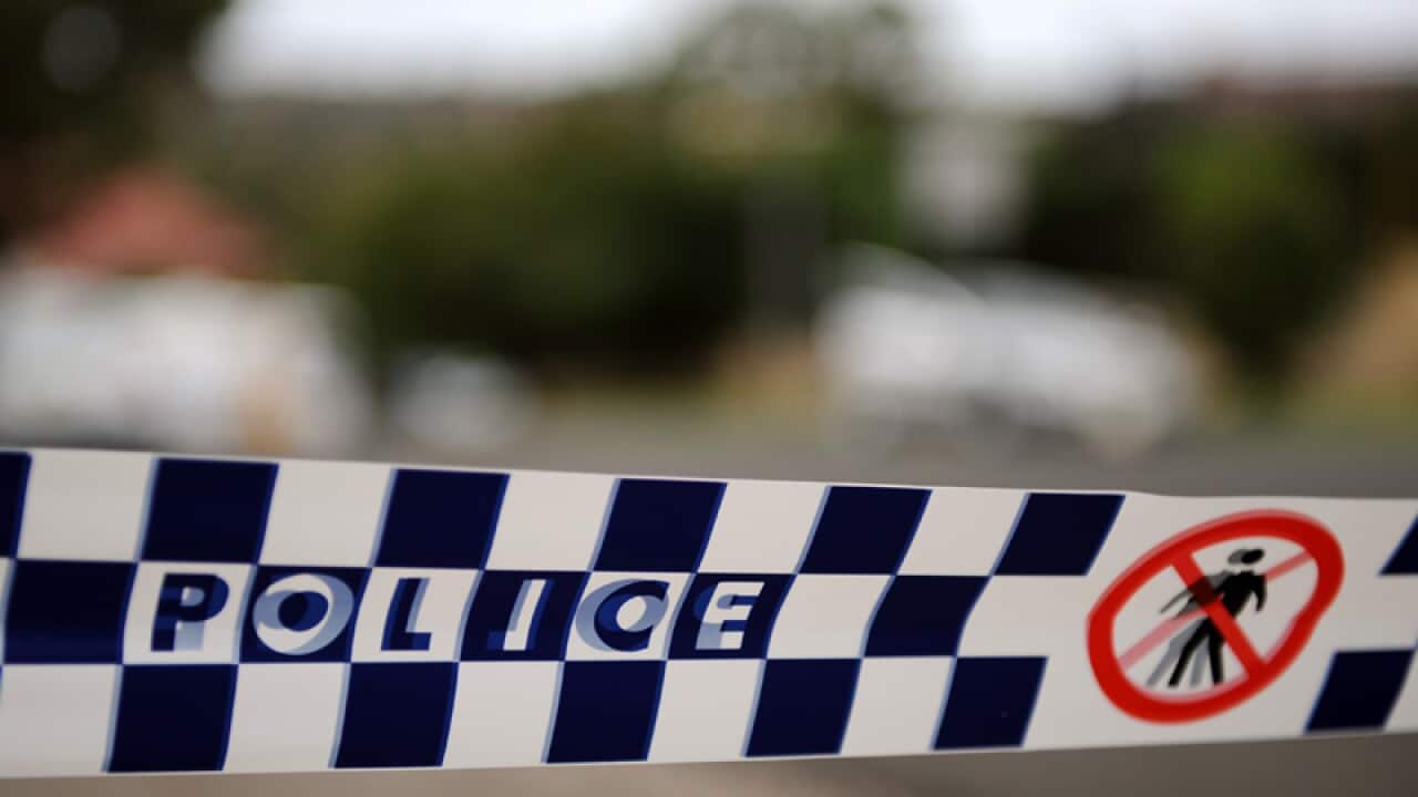 Police tape cordons off a scene.