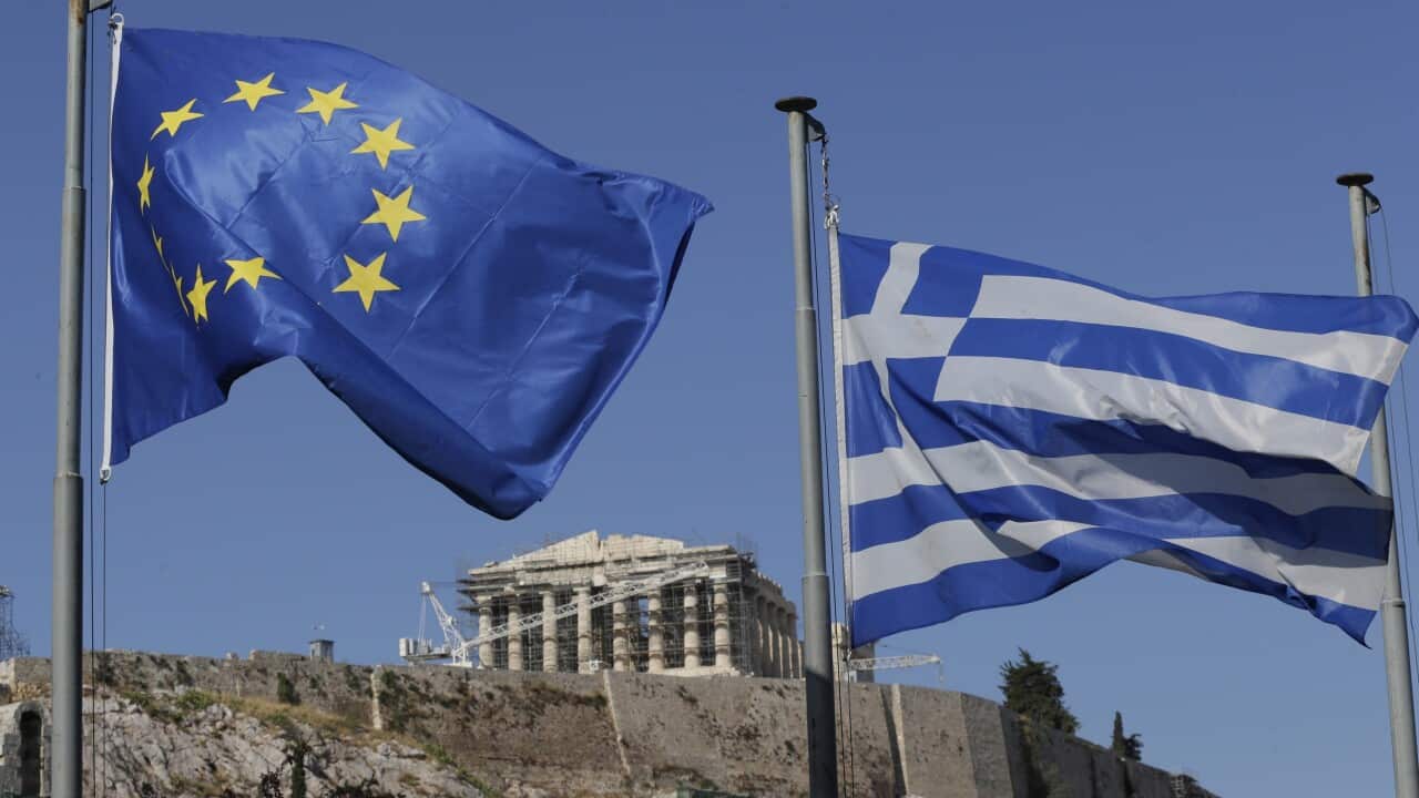 The Greek, right, and the European flags wave under the ancient Acropolis hill in Athens (AP Photo/Petr David Josek, File)