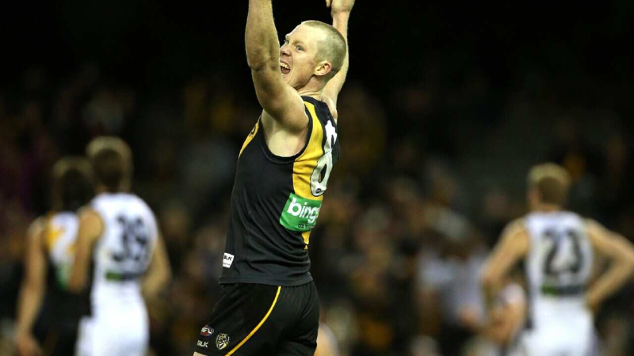 Jack Riewoldt of the Tigers celebrates their win against the Power
